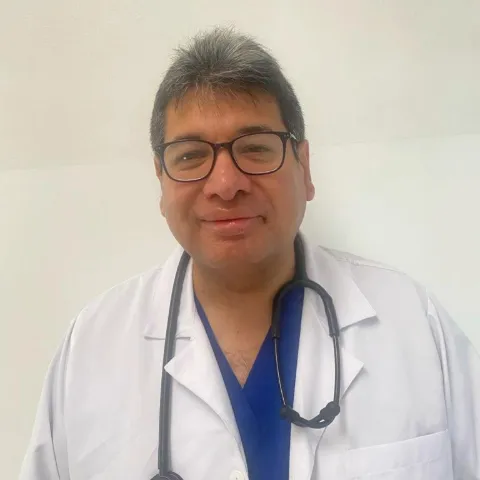 Doctor Rubén Contreras en fotografía profesional con uniforme médico.